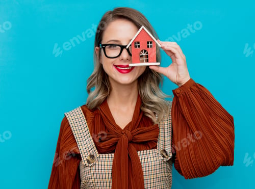 Preview: Youn woman with toy house