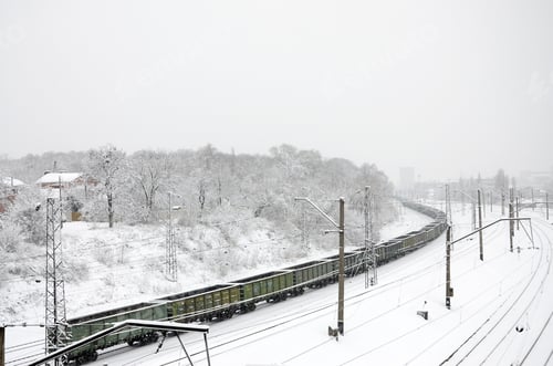 Preview: A long train of freight cars is moving along the railroad track