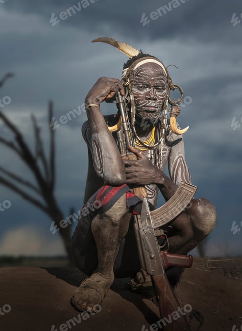 Preview: Young warrior of the Mursi tribe with Kalashnikov gun, Omo Valley, Ethiopia