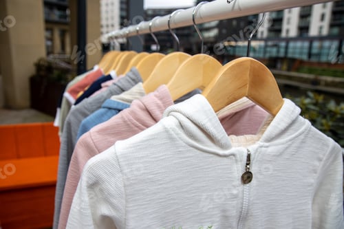 Preview: A Collection Of Clothes On A Clothes Rail Outside At A Car Boot Sale Or Yard Sale