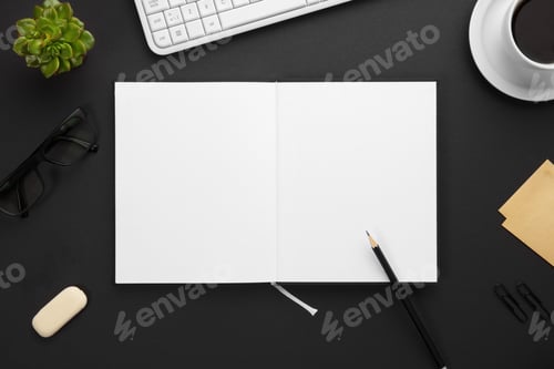 Preview: Top View of Blank Paper in Note Book Surrounded By Office Supplies On Gray Desk