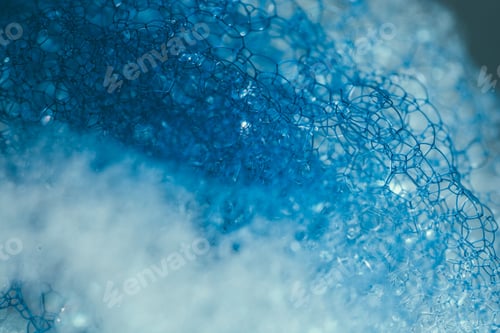 Preview: Closeup of blue translucent soap bubbles floating on the water surface, perfect for backgrounds