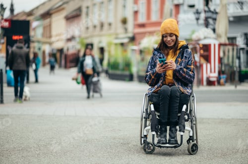 Preview: Woman with disability using a smartphone while out in the city