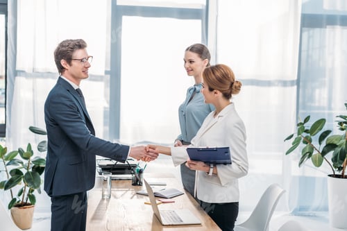 Preview: happy employee shaking hands with recruiter on job interview