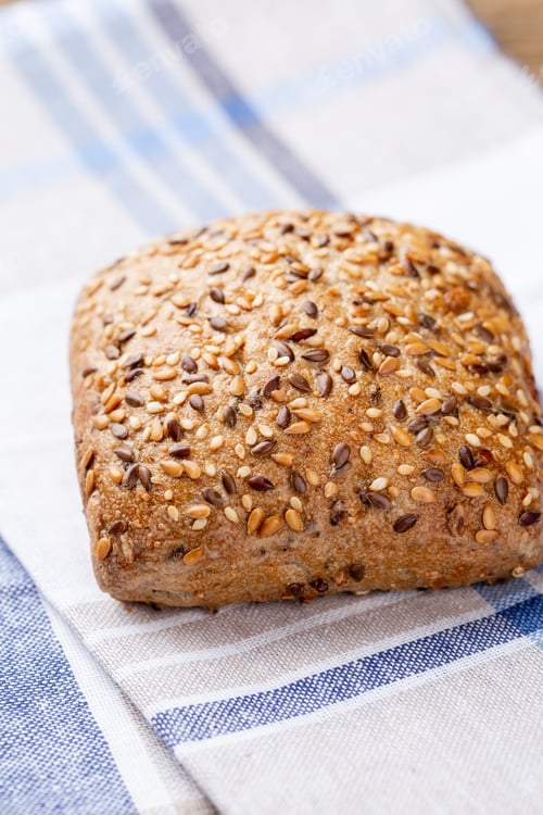 Preview: Freshly baked bread on dark gray kitchen table, top view.