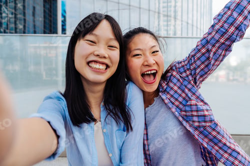 Preview: Happy beautiful chinese women friends bonding in the city