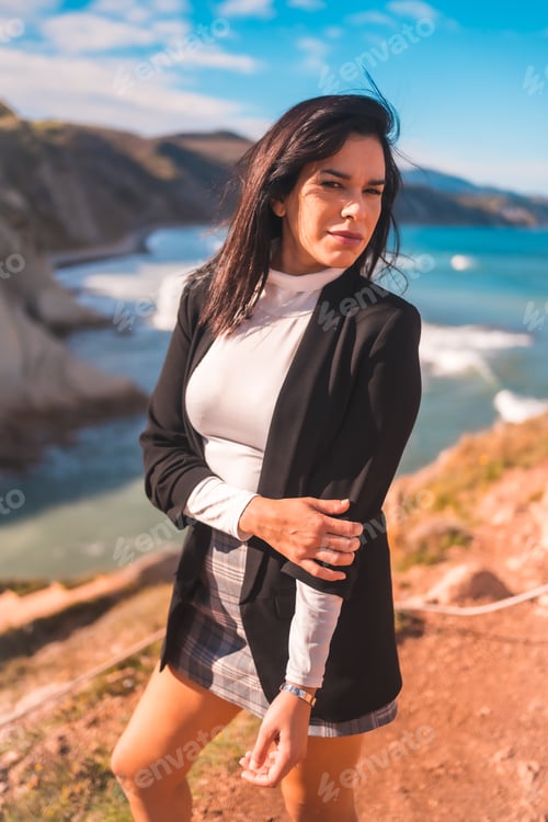 Preview: A young brunette enjoying a summer afternoon on the coast of the basque country