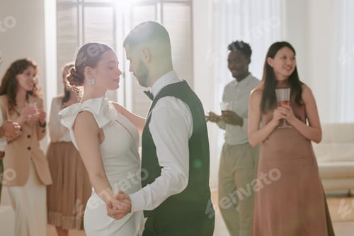 Preview: Caucasian Young Adult Bride and Groom Dancing during Wedding Celebration