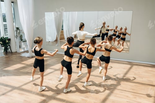 Preview: Looking at the mirror. Trainer is teaching girls ballet dancing