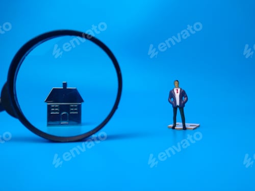 Preview: Miniature people,house keychain and magnifying glass on blue background. Real estate concept.