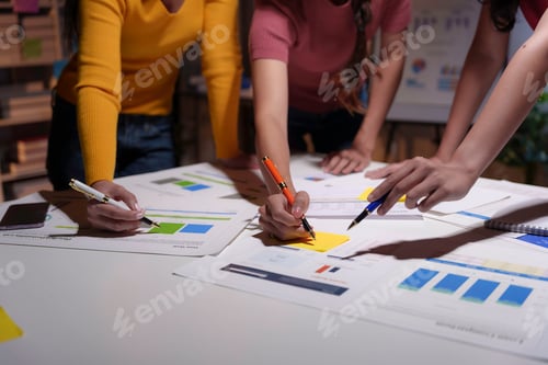 Preview: Team of marketing professionals are collaborating on a project, analyzing charts and graphs