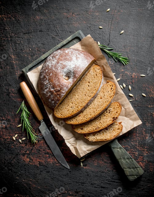 Preview: Sliced bread on a cutting Board with a knife and rosemary.