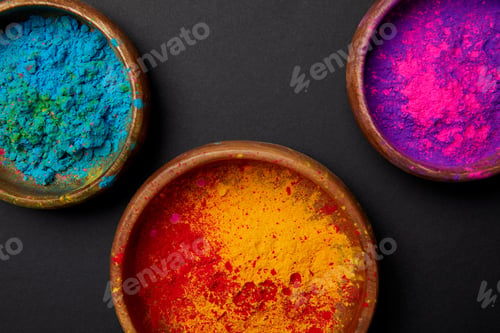 Preview: top view of colorful holi powder in paint on grey surface, Hindu spring festival