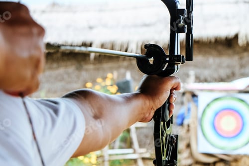 Preview: Archer holds his bow aiming at a target