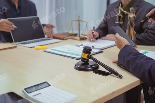 Preview: Three lawyers in a meeting at the table in an office, discussing business,civil and commercial law