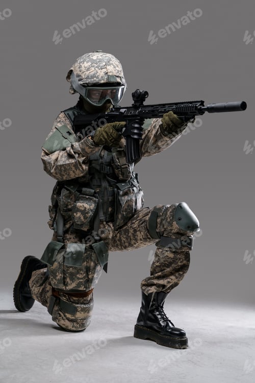 Preview: Modern servicewoman dressed in camouflage uniform aiming rifle