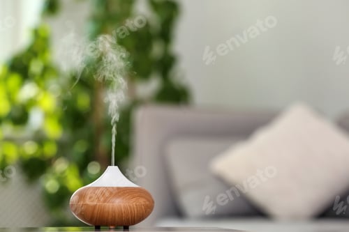 Preview: Aroma oil diffuser lamp on table against blurred background