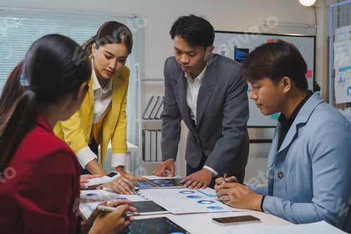 Preview: Asian businesspeople are working together, analyzing financial data, charts and graphs, developing g