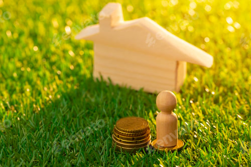 Preview: Wooden toy house miniature on grass close up
