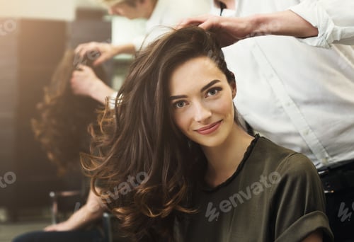 Preview: Woman sitting at beauty salon, making hairdo