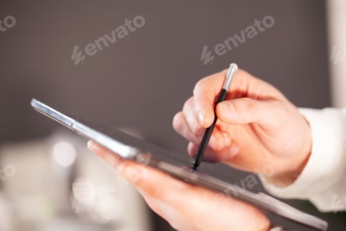 Preview: Man working on tablet at company office.