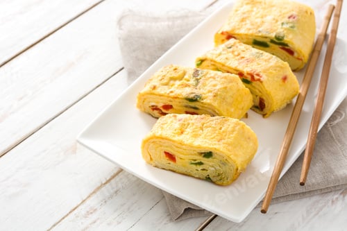 Preview: Tamagoyaki, japanese rolled omelette with vegetables, sliced and ready to eat