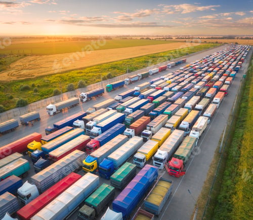 Preview: Aerial view of colorful trucks in terminal at sunset in summer