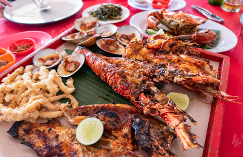 Preview: Seafood set with lobster, crab, fish, shrimp, shellfish on wooden tray in restaurant