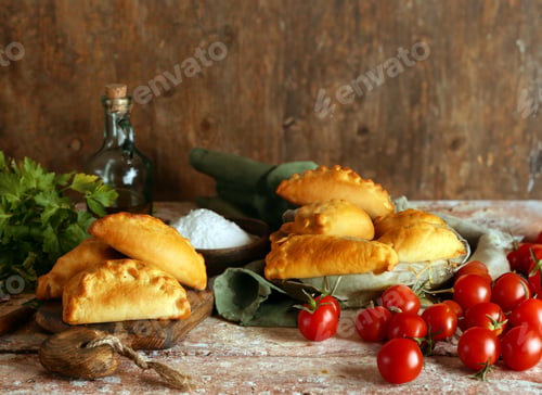 Preview: baked pies for snack on wooden table