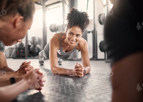 Preview: Happy black woman, group and plank in gym for health, fitness and wellness with strong core on floo