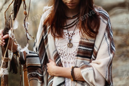 Preview: beautiful native indian american woman with warrior shaman make up on background of rocks