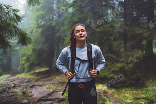 Preview: A person running through a misty forest, navigating over tree roots and muddy ground. The scene capt