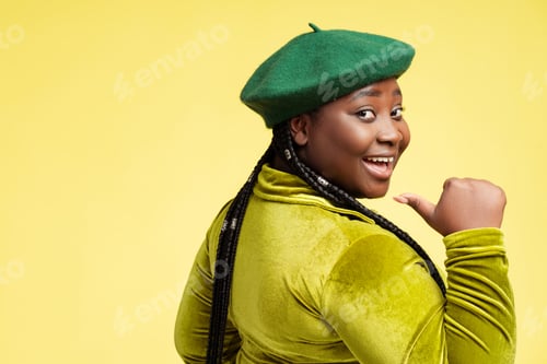 Preview: Beautiful smiling ethnic modern African American woman wearing stylish green beret and dress