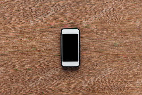 Preview: Top view of smartphone with blank screen on wooden background