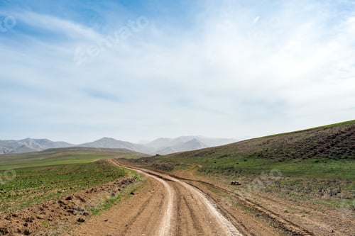 Preview: Country dirt road in mountains valley