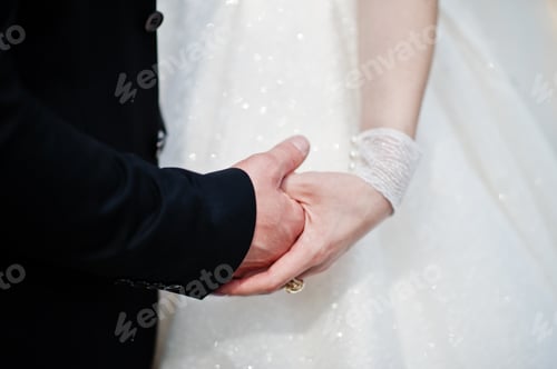 Preview: Wedding day. Hands in hands of newlywed couple.