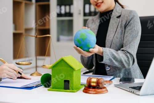 Preview: A lawyer presenting a green house model and earth globe with a gavel showing