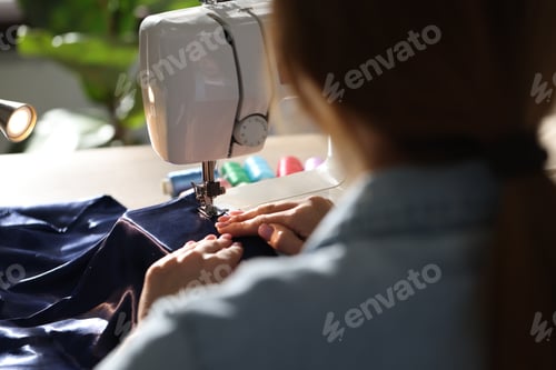 Preview: Woman working with sewing machine in workshop, closeup