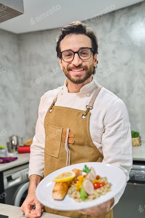 Preview: Chef smiling delivering plated gourmet meal