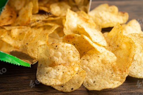 Preview: Potato chips, delicious spicy for crips, thin slice deep fried snack fast food in open bag.