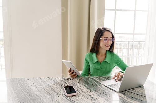 Preview: An assistant in the copywriter's office prints text using a computer and an online chatbot. A young