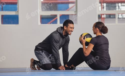 Preview: Shot of a young woman exercising with a trainer at the gym