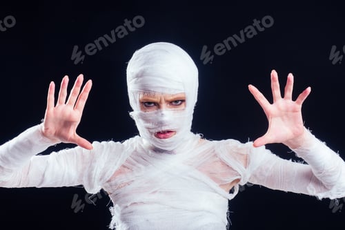 Preview: Glamorous mummy woman in bandages all over her body studio black background