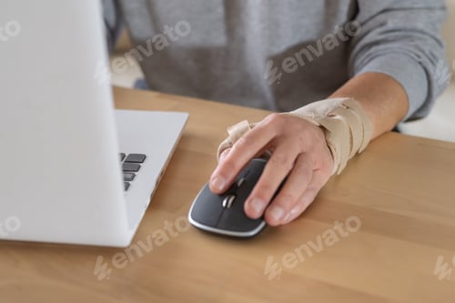 Preview: Person using computer mouse with wrist brace