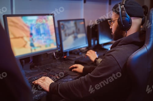 Preview: Team of teenage gamers plays in a multiplayer video game on pc in a gaming club.