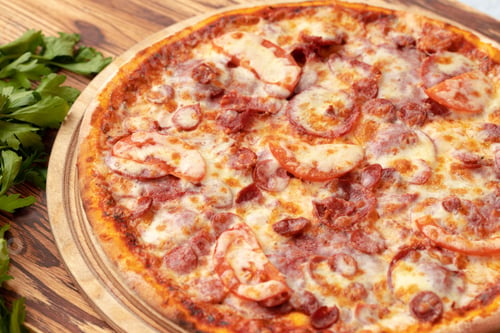 Preview: Freshly baked pizza on table close up