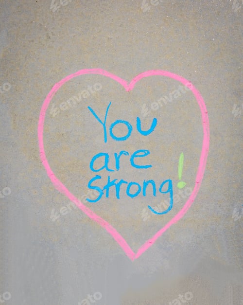 Preview: You are strong written in a heart in chalk on the sidewalk