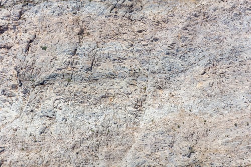 Preview: Grey rock background texture. Stone formation, rough natural material shaped by the sea, salt wind