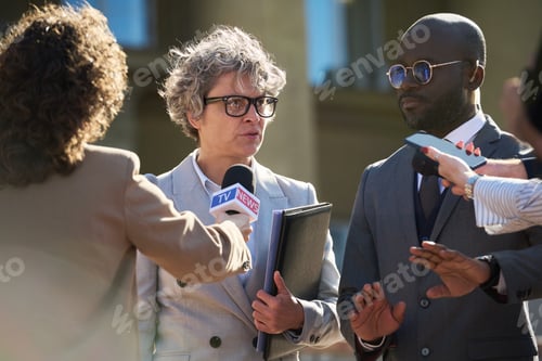 Preview: Middle Aged Caucasian Woman Giving Press Statement Surrounded by Reporters