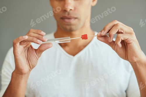 Preview: Close-up of man using cotton swab while doing PCR test.